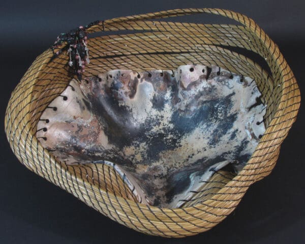 A basket called "Cradling the Cosmos" with a black and white pattern on it.