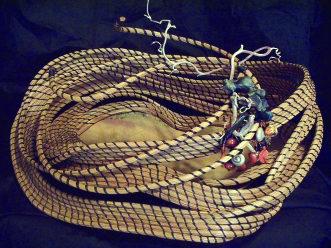 A basket with a snake on top of it.