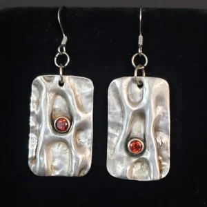 A pair of Air Chased Sterling Silver With Garnets earrings.