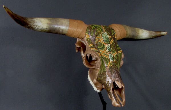 A Gordon Plaid of Eight Pond Farms skull with horns on a stand.
