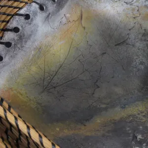 A close up of a metal basket with rust on it.