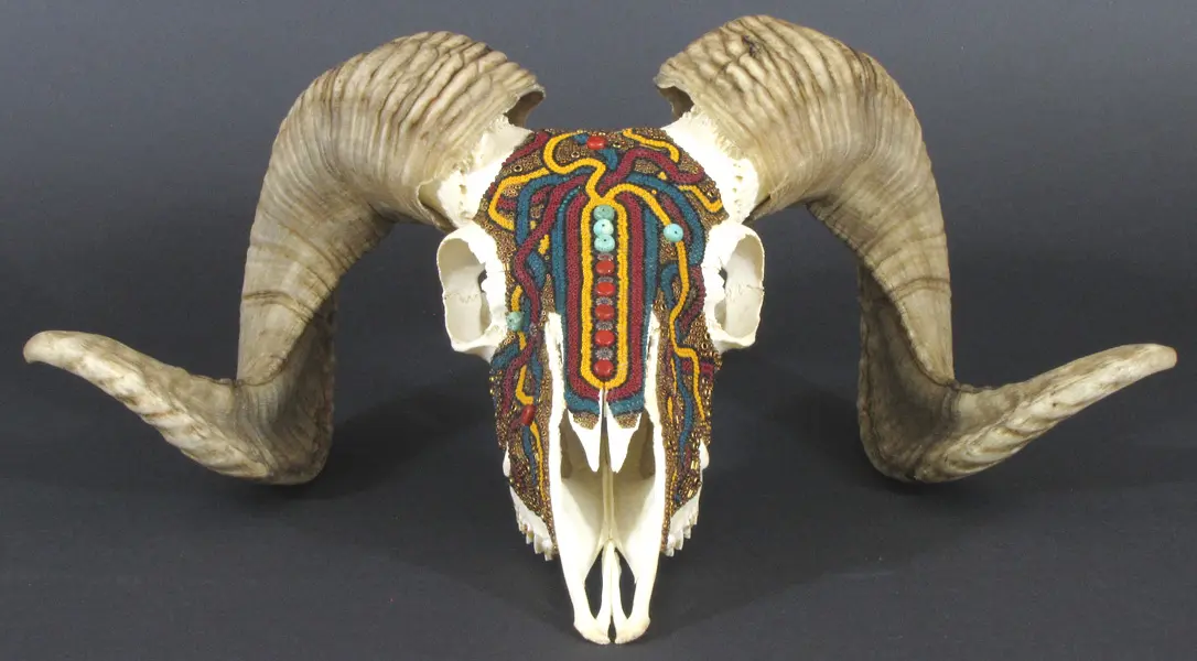 A ram skull with colorful designs on it.