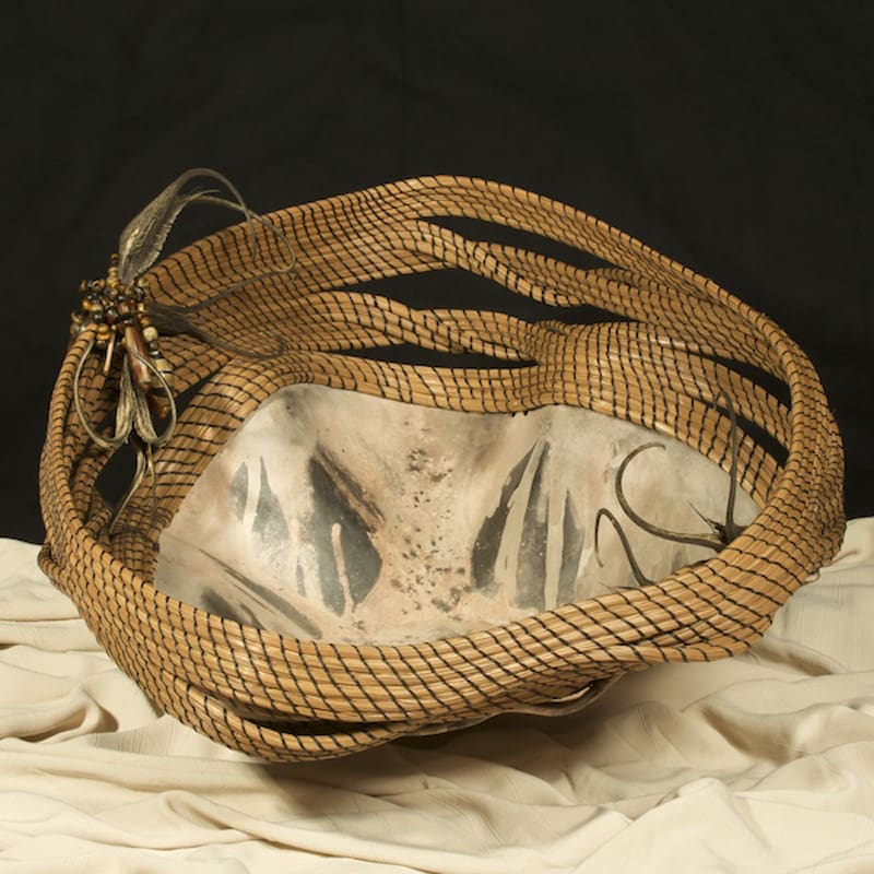 A woven basket on a white cloth.