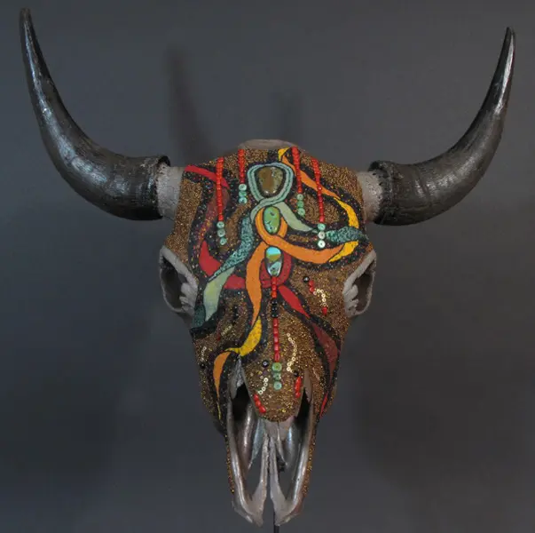 A bull skull with colorful designs on it.