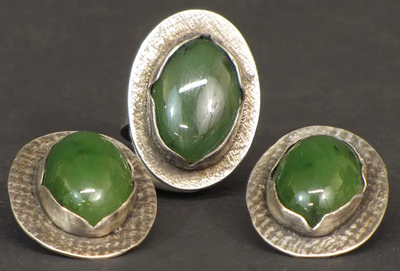 A pair of green jade ring and earring set.