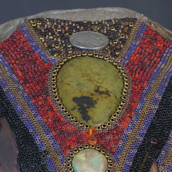A close up of a Thantanjka with beads on it.
