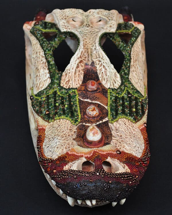 A Cajun Queen mask with a lot of decorations on it.
