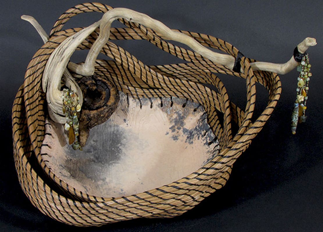 A bowl with a rope hanging from it.