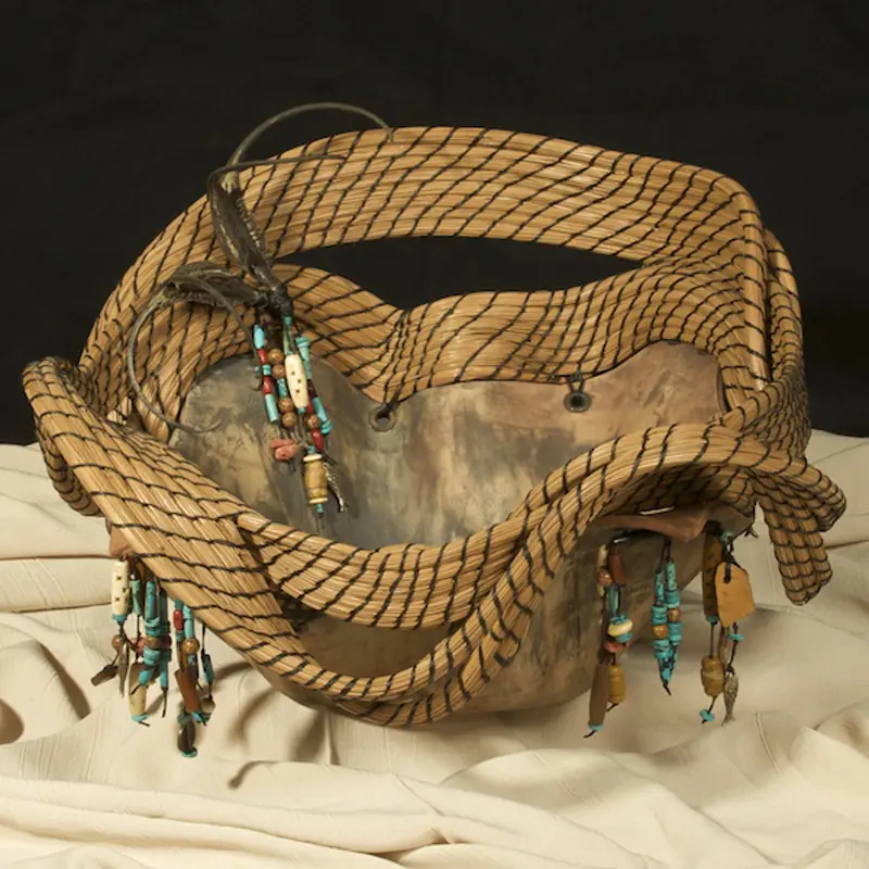 A basket with beads and twigs on it.