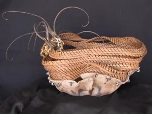 A wicker basket with feathers on it.