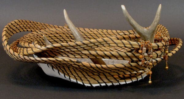 A basket with Twisted Fate antlers and a Twisted Fate beaded bracelet.