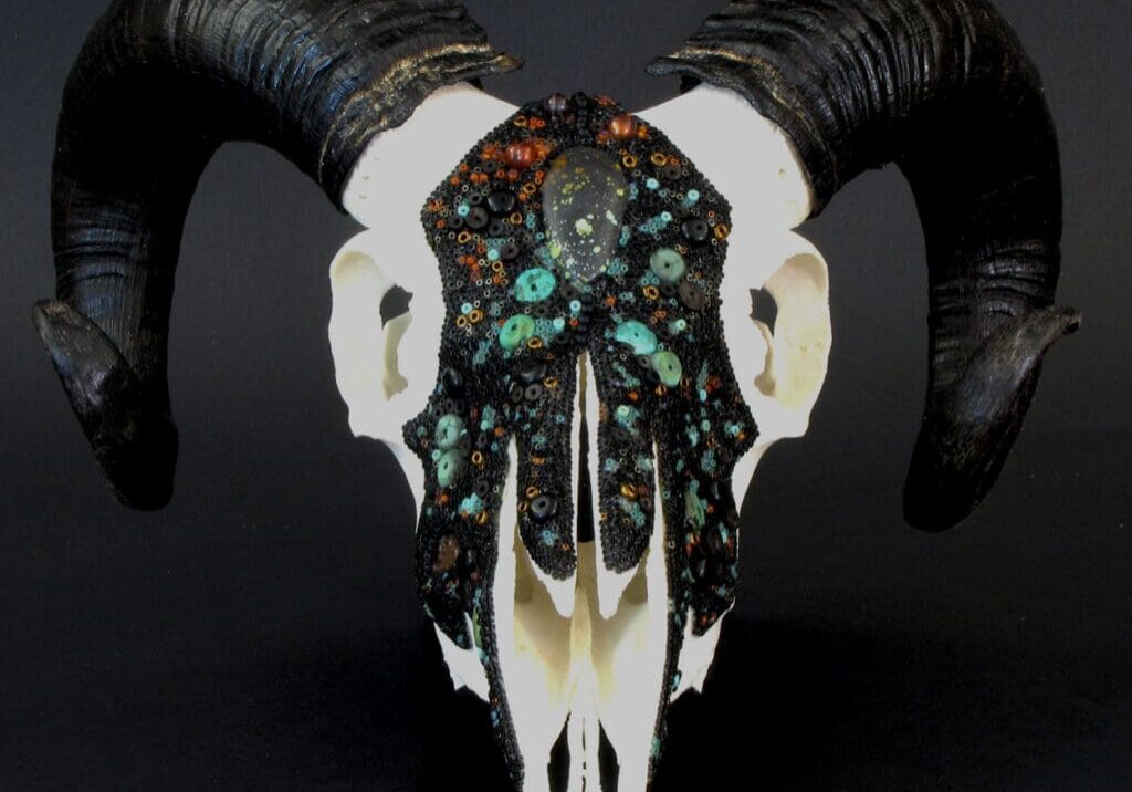 A Cradling the Cosmos with black and turquoise horns.