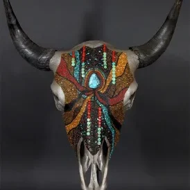 A bull skull with colorful beading on it.