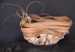 A wicker basket with feathers on it.